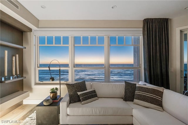 living room featuring a water view and wood-type flooring