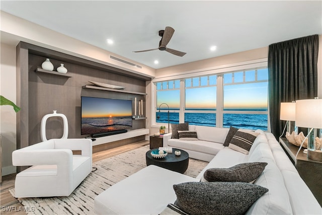 living room with ceiling fan and light hardwood / wood-style flooring