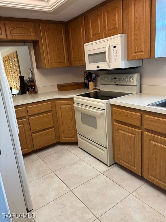 kitchen featuring white appliances and light tile patterned floors