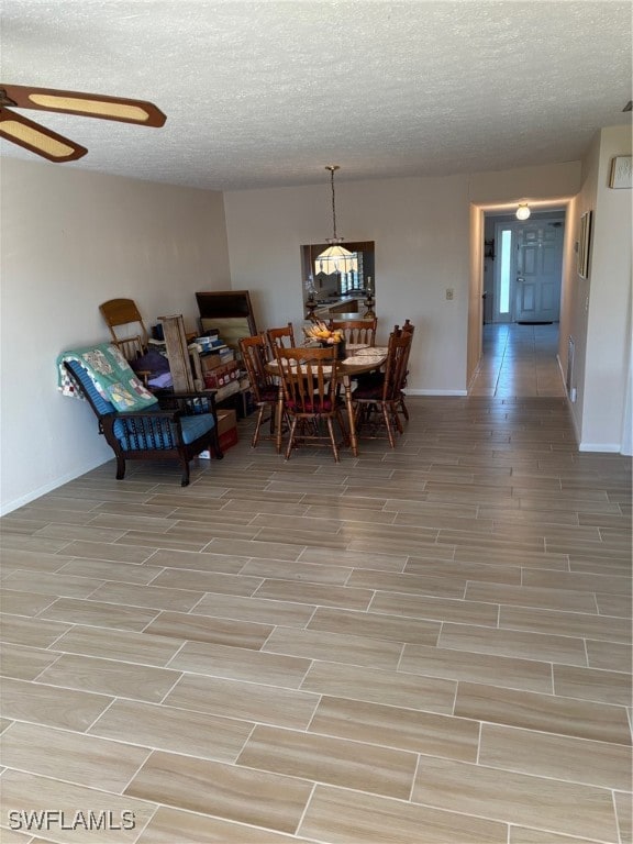 dining room with a textured ceiling and ceiling fan