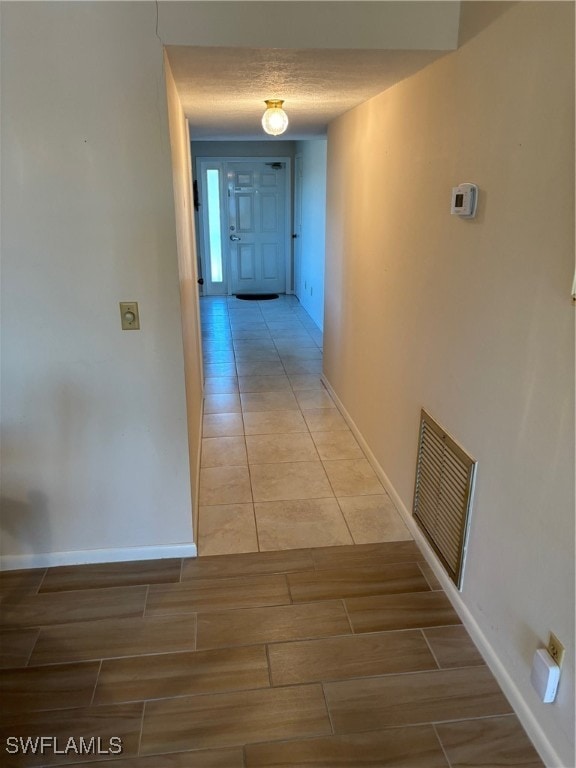 hallway with a textured ceiling