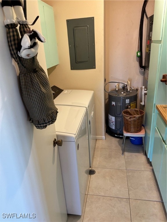 clothes washing area with electric panel, electric water heater, light tile patterned floors, and washer and dryer