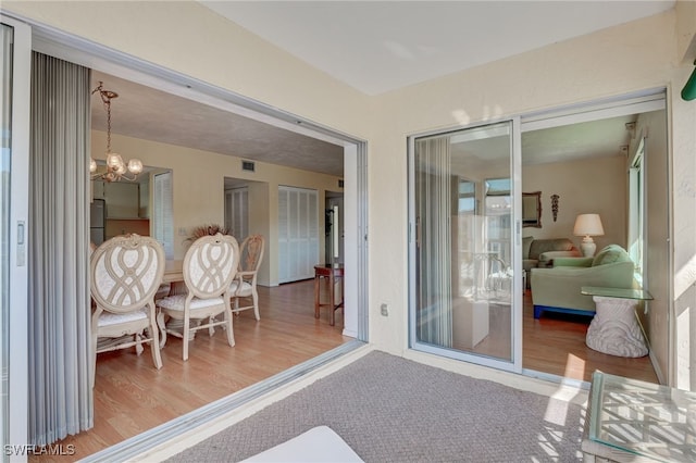 sunroom featuring an inviting chandelier