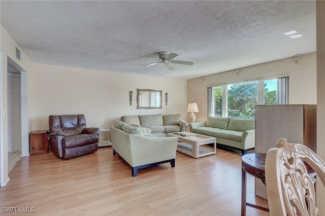 living room featuring ceiling fan and light hardwood / wood-style flooring