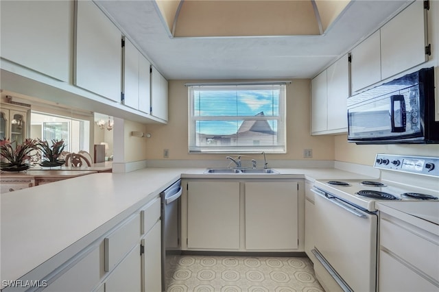 kitchen featuring sink, stainless steel dishwasher, a notable chandelier, white range with electric cooktop, and white cabinets