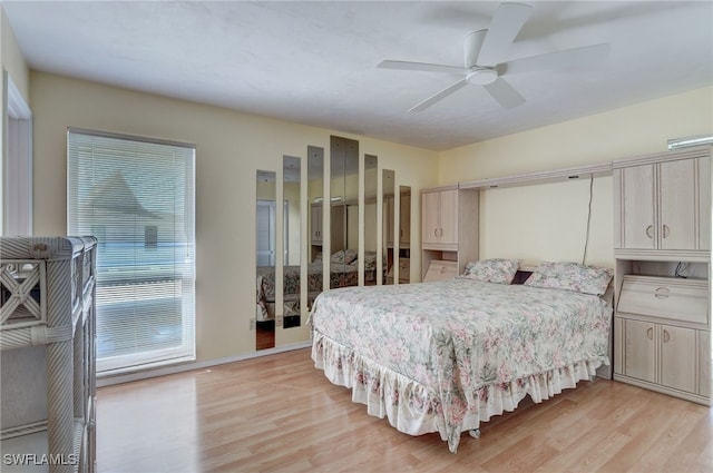 bedroom with light wood-type flooring and ceiling fan