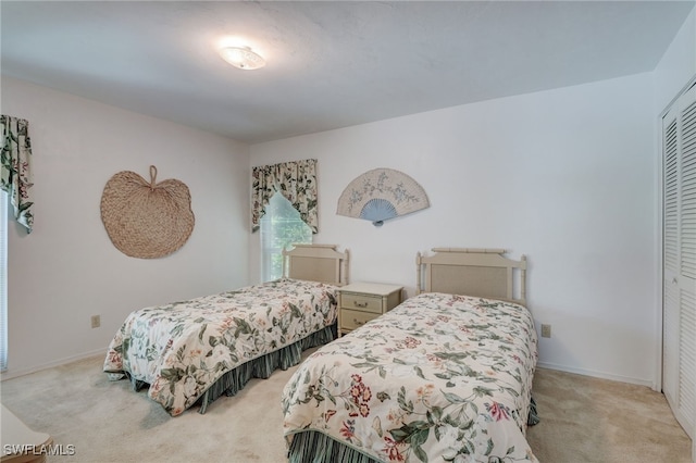 bedroom featuring light carpet and a closet