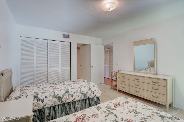 carpeted bedroom with a closet