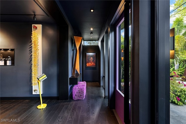 hallway with dark hardwood / wood-style flooring