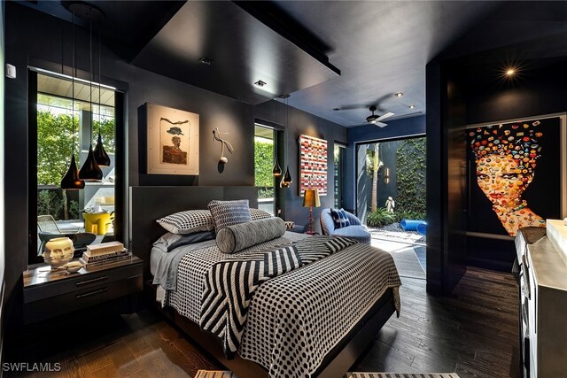 bedroom with access to outside, dark hardwood / wood-style floors, and multiple windows