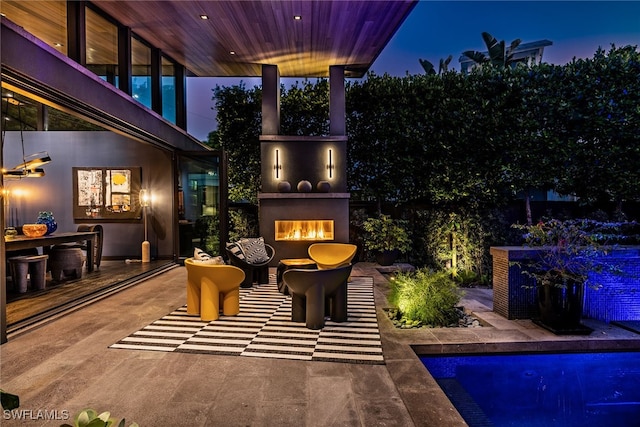 exterior space with a patio area and exterior fireplace