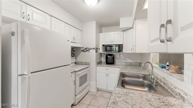 kitchen with white appliances, exhaust hood, white cabinets, sink, and tasteful backsplash