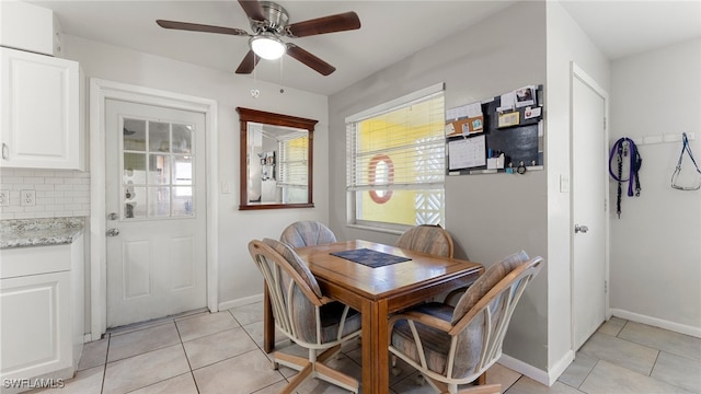 dining space featuring ceiling fan and light tile patterned floors