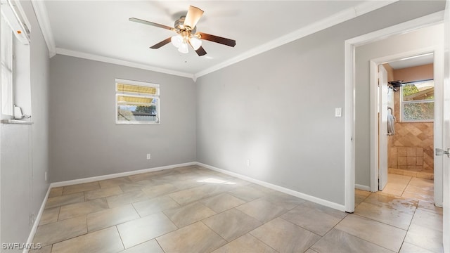 tiled spare room featuring a wealth of natural light, crown molding, and ceiling fan