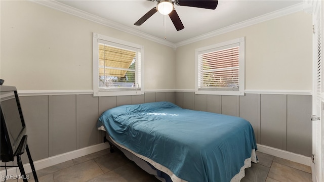 tiled bedroom with ceiling fan and crown molding