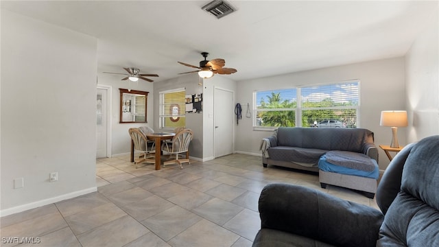 living room with ceiling fan and light tile patterned flooring