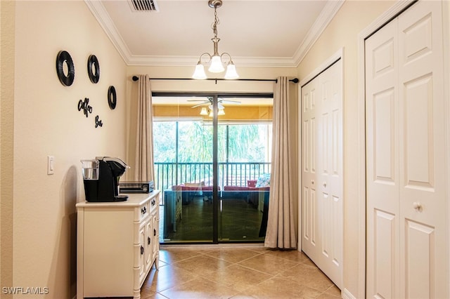 entryway featuring ceiling fan with notable chandelier, light tile patterned flooring, and crown molding