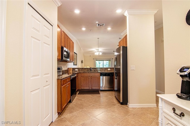 kitchen featuring appliances with stainless steel finishes, ornamental molding, sink, light tile patterned floors, and dark stone countertops