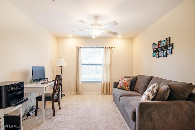 carpeted office space with ceiling fan