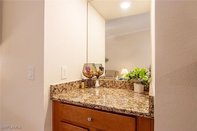 bathroom with vanity and ornamental molding