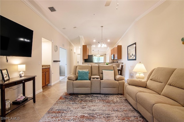 living room featuring ceiling fan with notable chandelier, light tile patterned flooring, and crown molding