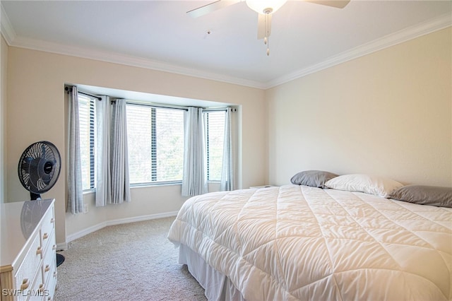 carpeted bedroom with ceiling fan and ornamental molding