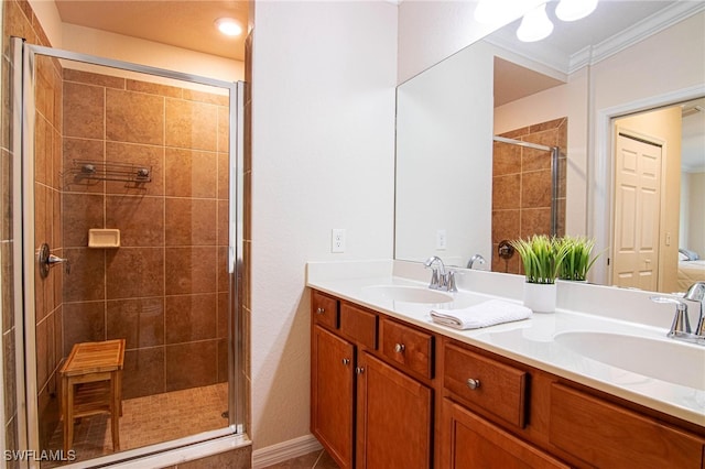 bathroom with vanity, a shower with door, and ornamental molding