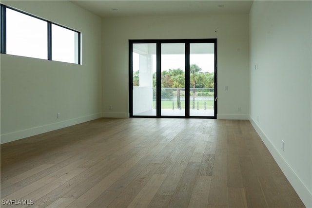 unfurnished room with light hardwood / wood-style flooring