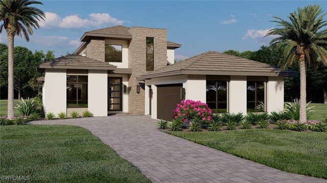 prairie-style home featuring a front yard and a garage