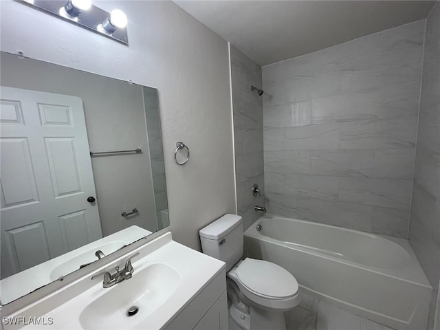 full bathroom with vanity, tiled shower / bath combo, and toilet