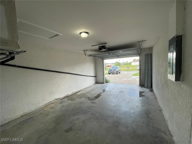 garage with electric panel and a garage door opener