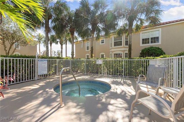 view of pool featuring a hot tub and a patio