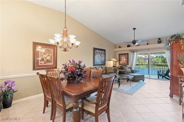 dining area with vaulted ceiling, ceiling fan with notable chandelier, and light tile patterned floors