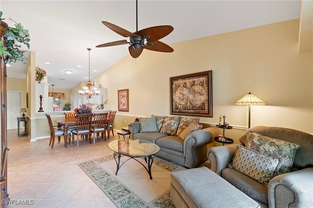 tiled living room with lofted ceiling and ceiling fan with notable chandelier