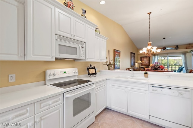 kitchen with lofted ceiling, sink, white appliances, light tile patterned floors, and white cabinets