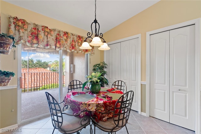 dining area with lofted ceiling and light tile patterned floors