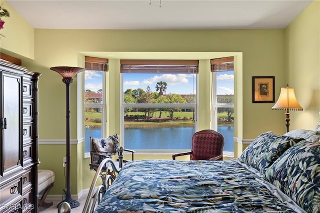 bedroom featuring a water view and carpet flooring