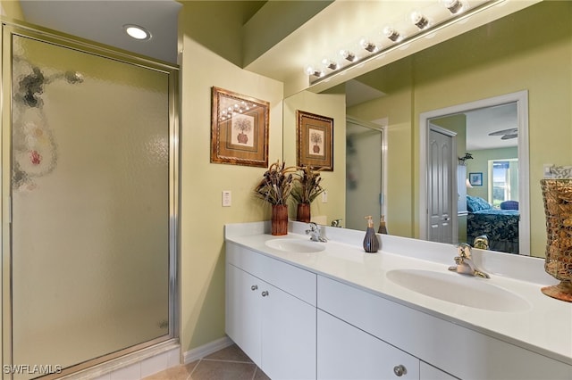 bathroom with vanity, a shower with door, and tile patterned floors