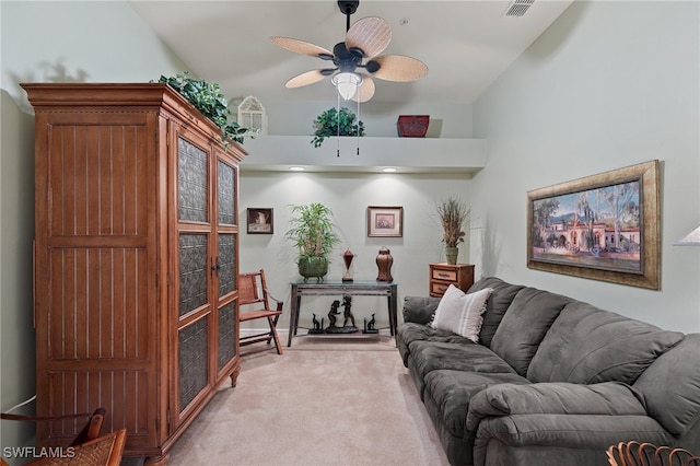 carpeted living room featuring ceiling fan and lofted ceiling