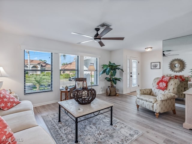 living room with light wood-type flooring and ceiling fan