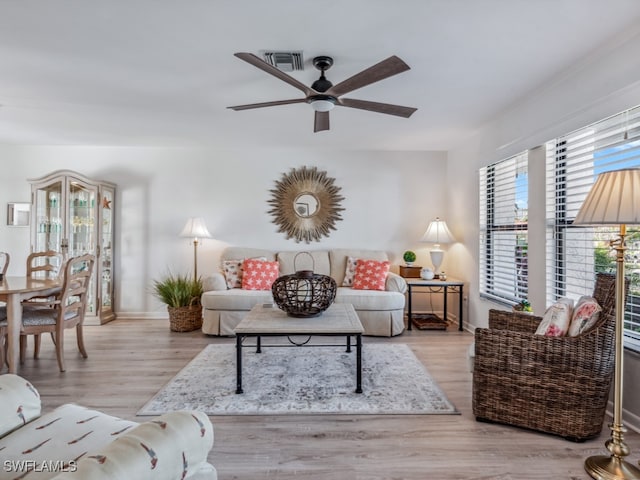 living room featuring ceiling fan and light hardwood / wood-style flooring