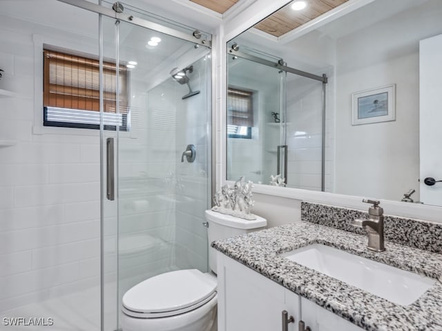 bathroom with vanity, toilet, and an enclosed shower