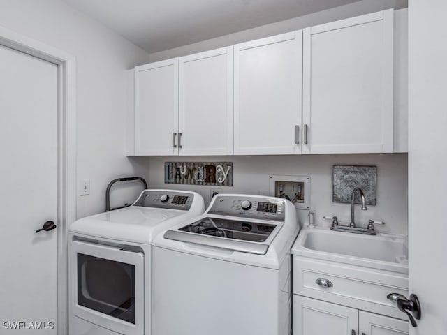 laundry area with cabinets, sink, and washing machine and clothes dryer