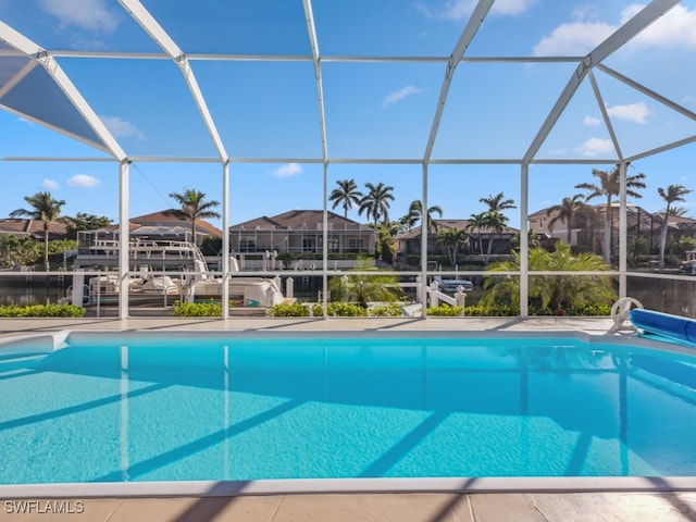 view of swimming pool with glass enclosure