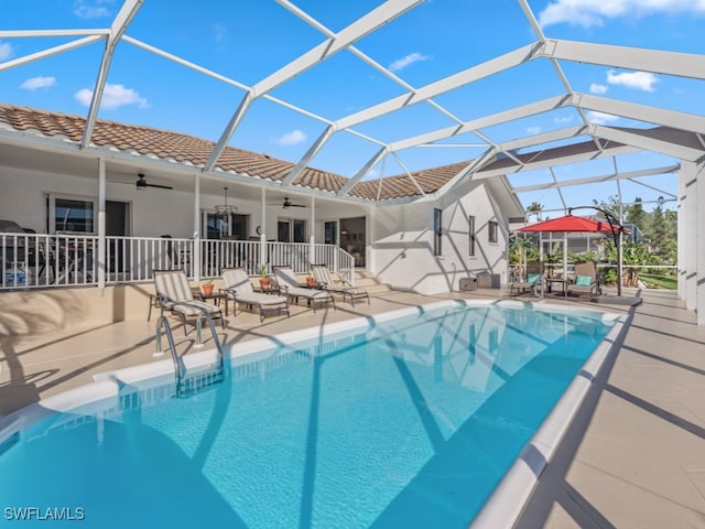 view of pool with a patio area, ceiling fan, and a lanai