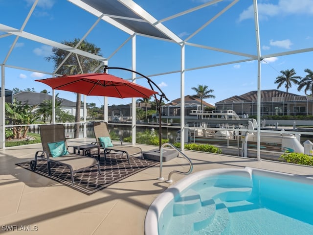 view of pool with a lanai, a water view, and a patio