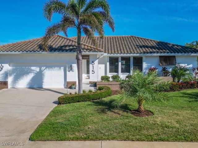 view of front of home with a garage and a front lawn