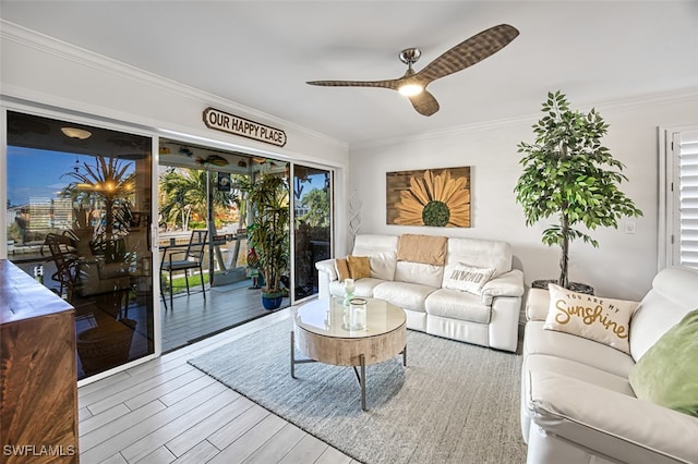 living room featuring a wealth of natural light, hardwood / wood-style floors, and crown molding