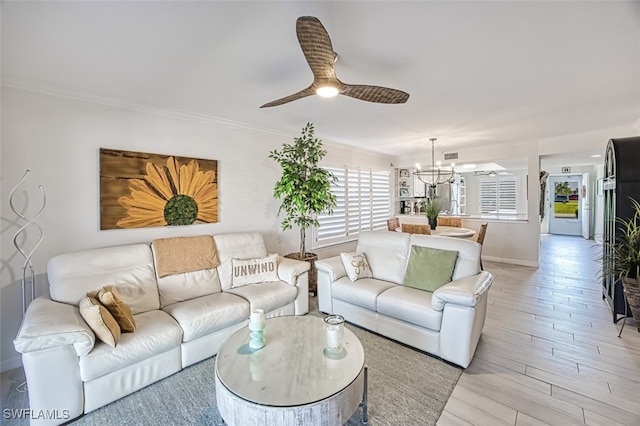 living room with ceiling fan with notable chandelier, light hardwood / wood-style floors, and ornamental molding