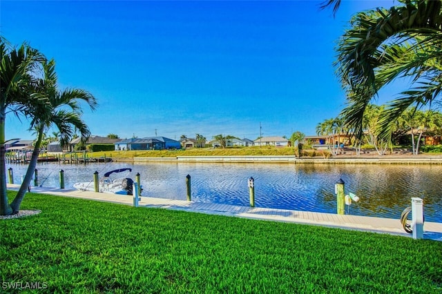 dock area featuring a lawn and a water view